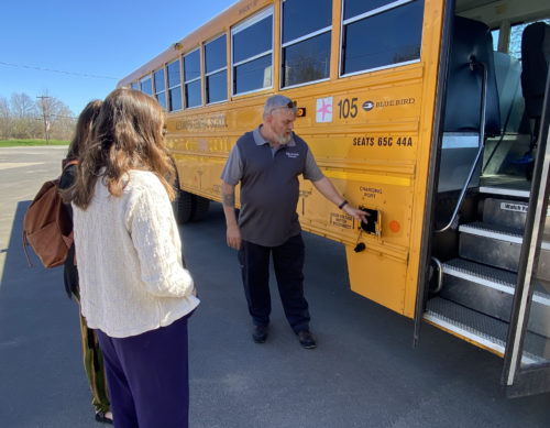 Delmar Lambert, Transportation Supervisor of Alexandria Central School District, showing off the district's new electric bus. 